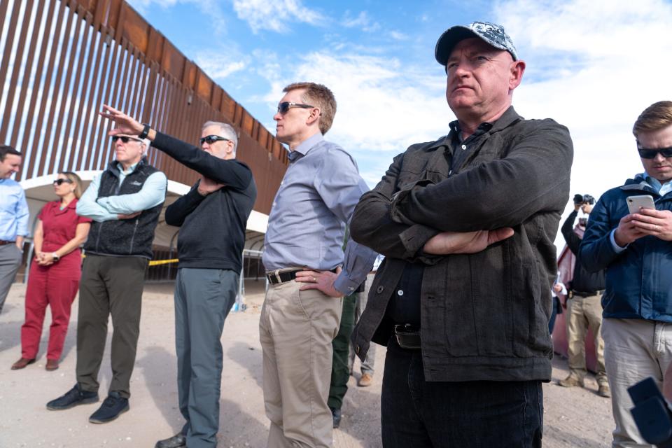 U.S. Sen. Mark Kelly, D-Ariz., right, and other senators visit the U.S.-Mexico border in Somerton, Ariz., near the Cocopah Indian Reservation boundary on Jan. 10, 2023.