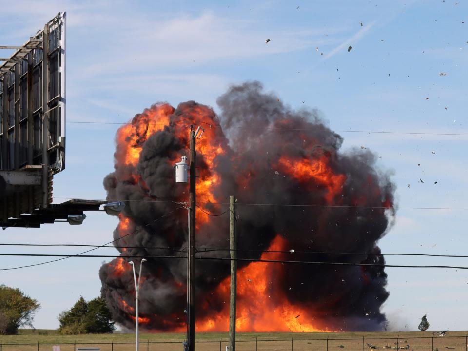 A historic military plane crashes after colliding with another plane during an airshow at Dallas Executive Airport in Dallas on Saturday, Nov. 12, 2022.