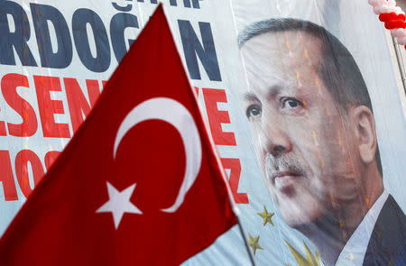A huge banner with a picture of Turkish President Tayyip Erdogan is seen on a building during a ceremony in Istanbul, Turkey, March 26, 2017. REUTERS/Murad Sezer