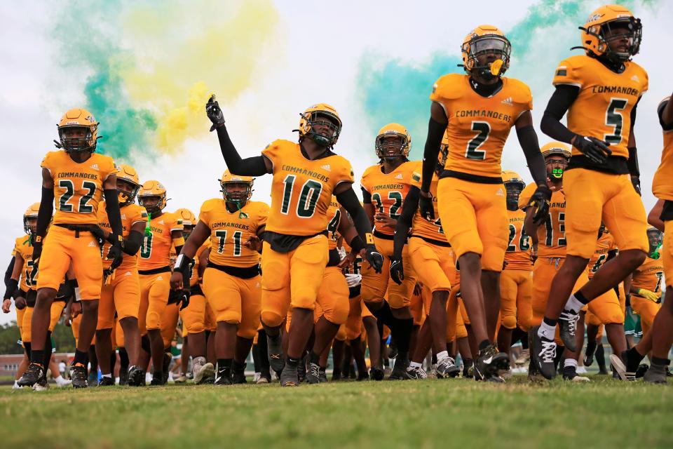 From left, Ed White's Derrick Brown (22), Nick Roberson (0), Hans Previna (71), Javon Johnson (10), Troy Butler (32), Joshua Patterson (2), and Noah Johnson (5) take to the field before a Sept. 1 game. The Commanders face Riverside for a potential district title on Friday.
