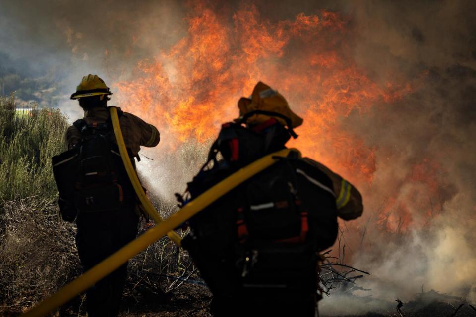 Fire crews battle a hot spot on Orwin road.