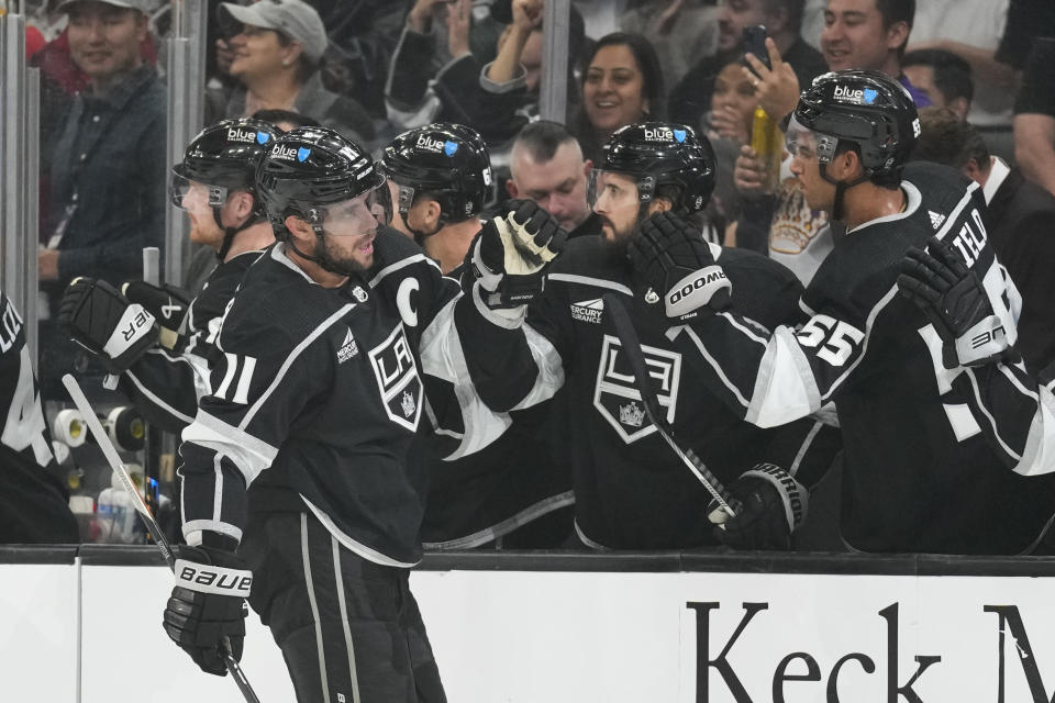 Los Angeles Kings center Anze Kopitar (11) celebrates with teammates after scoring during the first period of an NHL hockey game against the Arizona Coyotes Tuesday, Oct. 24, 2023, in Los Angeles. (AP Photo/Ashley Landis)