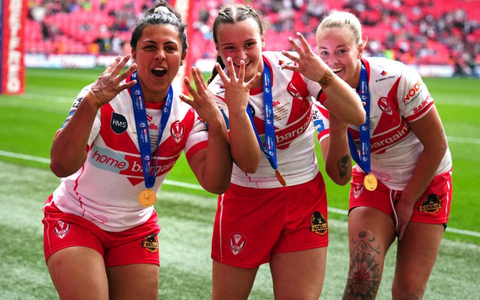 St Helens' Georgia Sutherland, Luci McColm and Naomi Williams celebrate after winning the Women's Challenge Cup final and raise their fingers to mark four straight wins