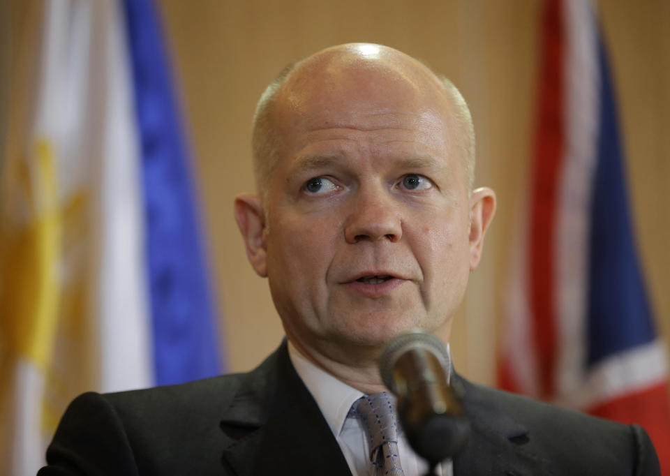 British Foreign Secretary William Hague answers questions from the media during a joint news conference with his Philippine counterpart Albert Del Rosario Thursday, Jan. 30, 2014 in Manila, Philippines. Hague said the United Kingdom will take in some refugees from the Syrian conflict to "give them some respite and some care after some of the things that they have been through." (AP Photo/Bullit Marquez)