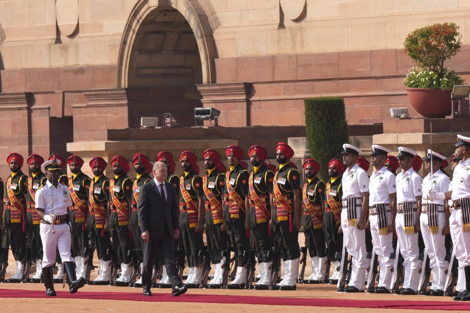 German Chancellor Olaf Scholz, inspects a joint military guard of honour during his ceremonial reception at the Indian presidential palace in New Delhi, India, Saturday, Feb. 25, 2023. (AP Photo/Manish Swarup)