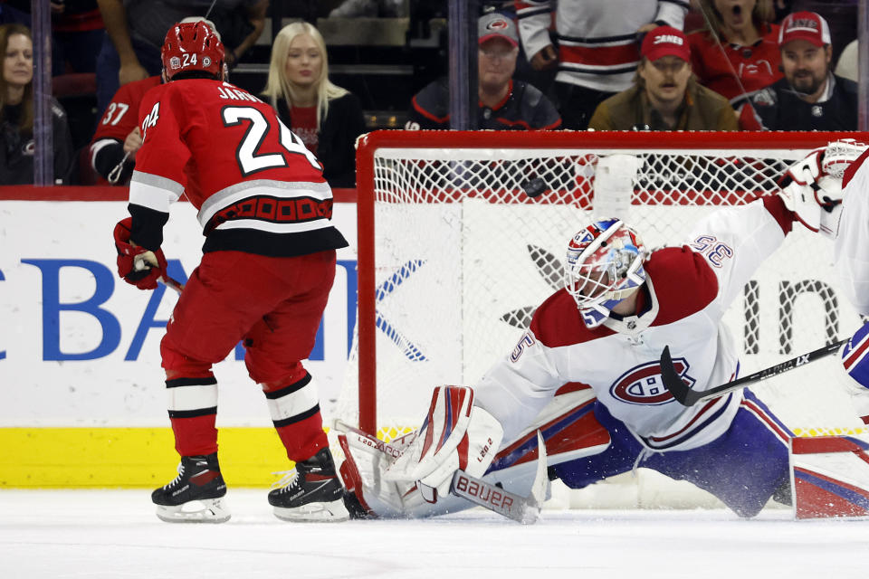 Carolina Hurricanes' Seth Jarvis (24) shoots the puck past Montreal Canadiens goaltender Sam Montembeault (35) for a hat trick during the third period of an NHL hockey game in Raleigh, N.C., Thursday, Feb. 16, 2023. (AP Photo/Karl B DeBlaker)