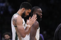 Boston Celtics forward Jayson Tatum pauses while walking on the court with teammate Jaylen Brown prior to the first half of an NBA basketball game against the Phoenix Suns, Thursday, March 14, 2024, in Boston. (AP Photo/Charles Krupa)