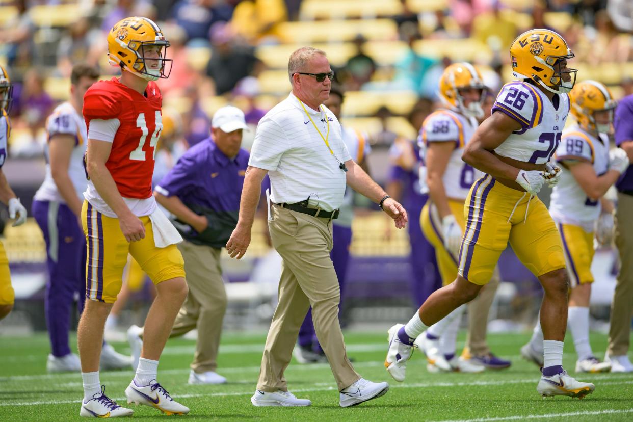 LSU quarterback Max Johnson (14) walks with LSU head coach Brian Kelly during the Spring football game in Baton Rouge, La. in April.