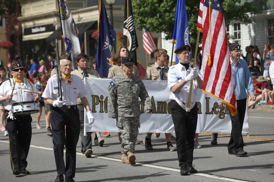 Members of the Rayson-Miller Pittsford American Legion Post 899 lead a Memorial Day parade.