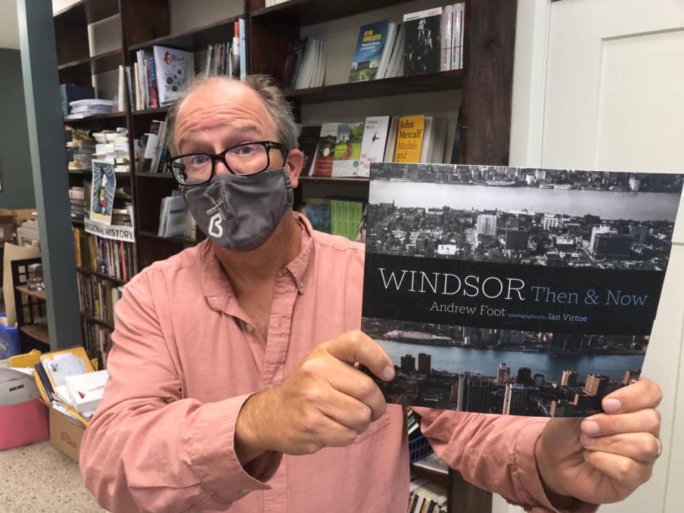 Biblioasis publisher Dan Wells holds a copy of a book they are publishing which took a month longer to come in than normal. (Dale Molnar/CBC - image credit)