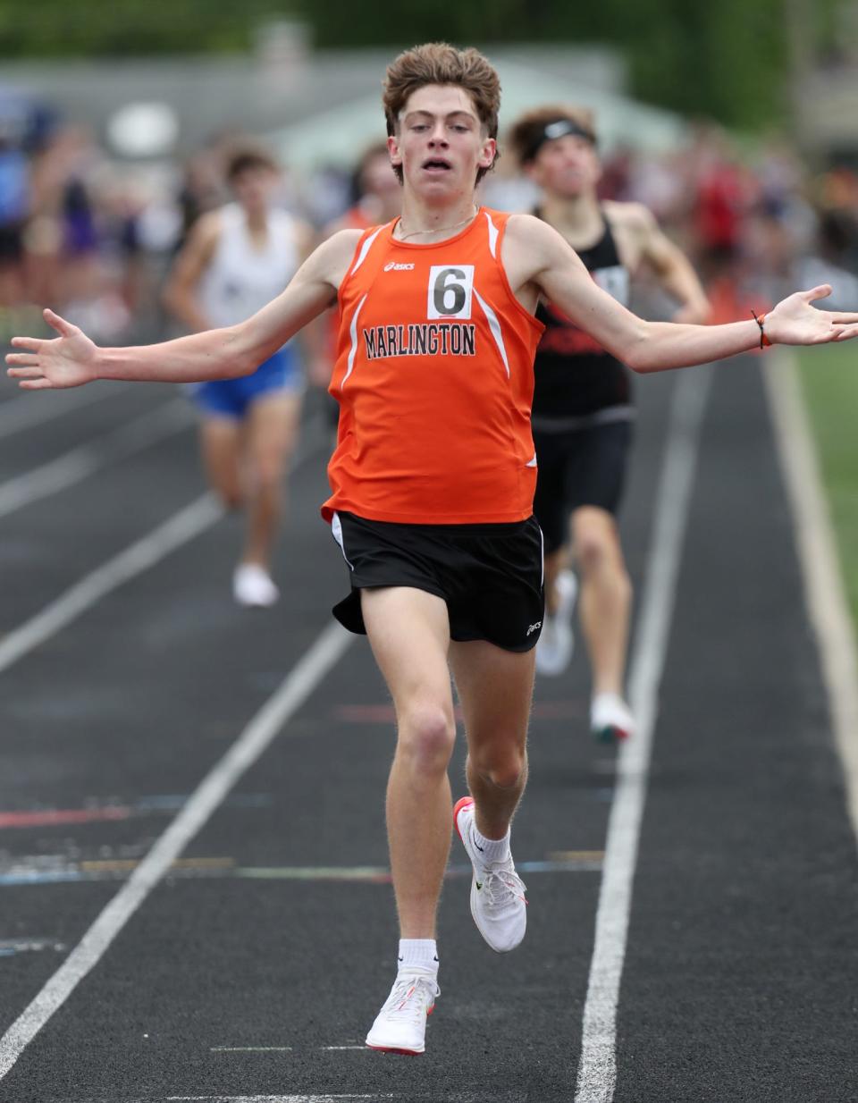 Marlington's Colin Cernansky reacts as he crosses the finish line to win the 1,600 meters in the Division II regional meet at Austintown Fitch High School on Saturday, May 28, 2022.