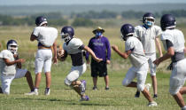 Thrall High School football players, wearing face masks at all times and using social distancing when possible, go through a practice, Thursday, Aug. 13, 2020, in Thrall, Texas. Coronavirus testing in Texas has dropped significantly, mirroring nationwide trends, just as schools reopen and football teams charge ahead with plans to play. (AP Photo/Eric Gay)
