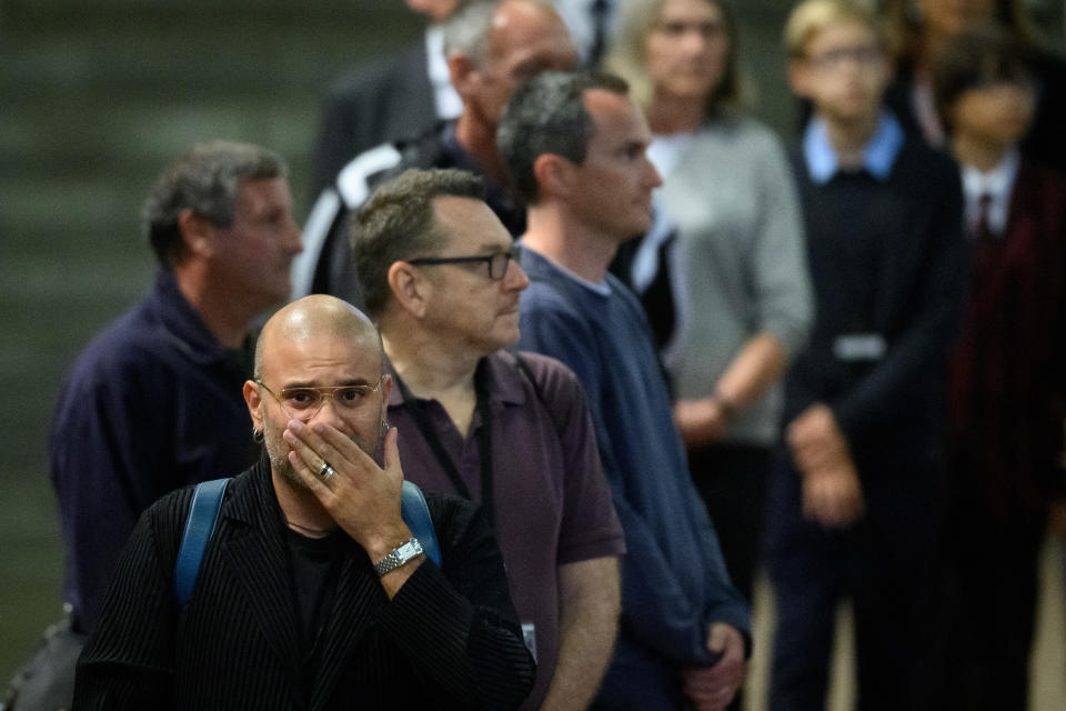 LONDON, ENGLAND - SEPTEMBER 15: Members of the public react after paying their respects to Queen Elizabeth II at Westminster Hall on September 15, 2022 in London, England.  Leon Neal/Pool via REUTERS