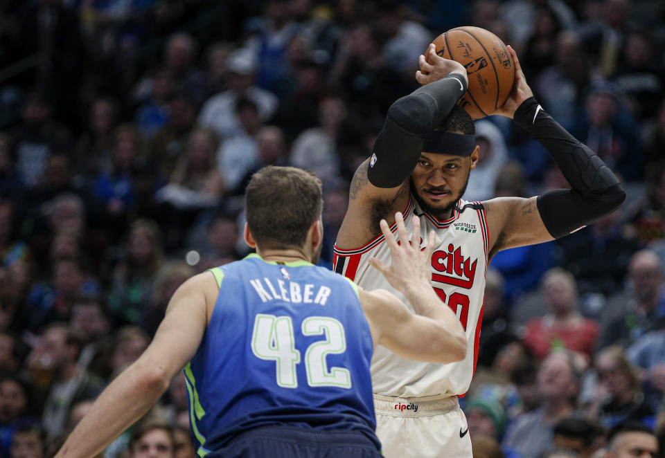 Portland Trail Blazers forward Carmelo Anthony (00) is defended by Dallas Mavericks forward Maxi Kleber (42) during the second half of an NBA basketball game Friday, Jan. 17, 2020, in Dallas. Dallas won 120-112. (AP Photo/Brandon Wade)