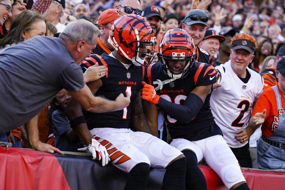 Cincinnati Bengals wide receiver Ja'Marr Chase (1) celebrates his touchdown with wide receiver Tyler Boyd and fans in the first half of an NFL football game against the Atlanta Falcons in Cincinnati, Sunday, Oct. 23, 2022. (AP Photo/Jeff Dean)