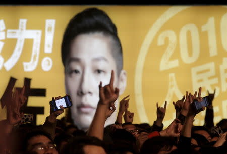 Supporters of Freddy Lim, a candidate to the 2016 legislative election and singer of death metal band Chthonic, raise their hands during a concert to boost Lim's campaign in Taipei, Taiwan, December 26, 2015. REUTERS/Pichi Chuang