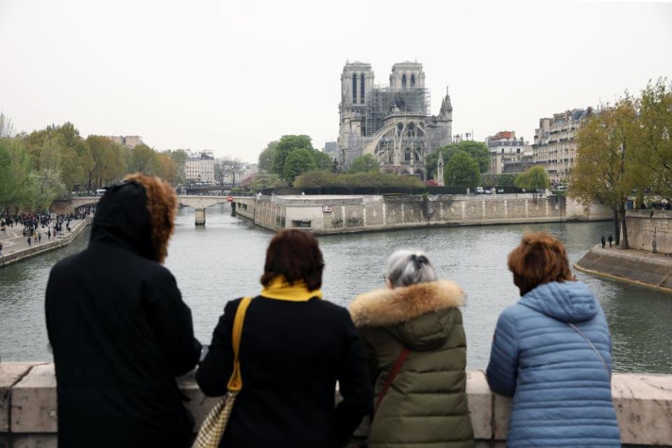 Onlookers gaze at the damage caused to Notre-Dame Cathedral following a major fire on April 16, 2019 in Paris, France. (Photo by Dan Kitwood/Getty Images)