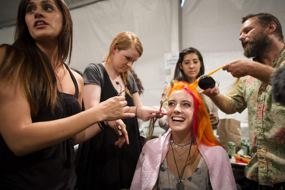 A model has her hair done backstage before the Nicole Miller Spring 2013 collection is modeled during Fashion Week in New York, Friday, Sept. 7, 2012. (AP Photo/John Minchillo)