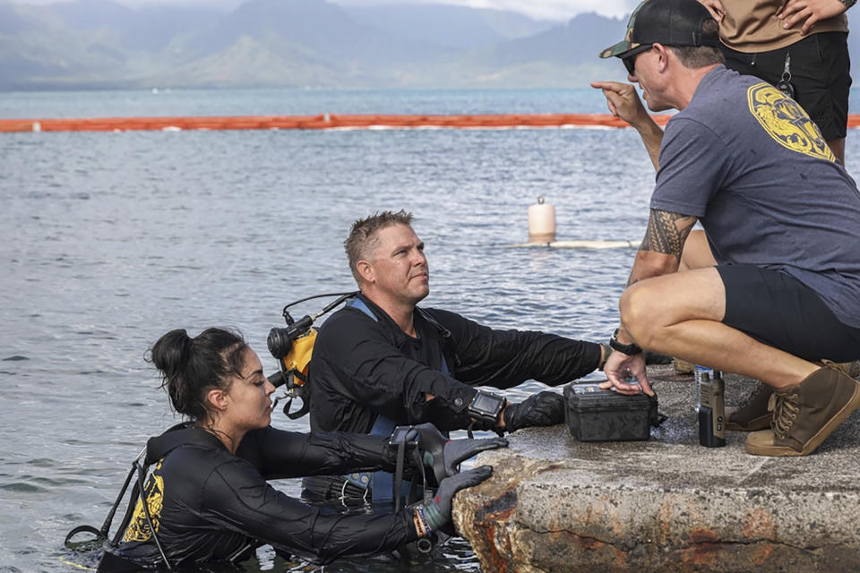 This photo provided by U.S. Marine Corps, U.S. Navy Sailors with Company 1-3, Mobile Diving and Salvage Unit 1, retrieved the aircraft flight recorder from a downed U.S. Navy P-8A Poseidon and are debriefed in waters just off the runway at Marine Corps Air Station Kaneohe Bay, Marine Corps Base Hawaii, Thursday, Nov. 23, 2023. The flight data recorder has been recovered as the military continues to plan for the aircraft’s removal.(Lance Cpl. Hunter Jones/U.S. Marine Corps via AP)