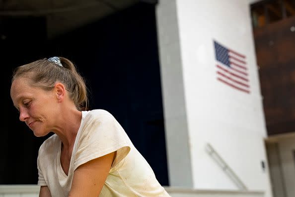 April Stivers, 38, of Lost Creek, Kentucky, takes a moment to herself in the Hazard Community & Technical College, where survivors of the major flooding in eastern Kentucky are being taken for shelter on July 28, 2022, in Breathitt County, Kentucky.