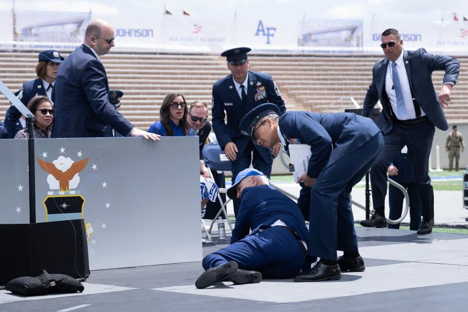 US President Joe Biden is helped up after falling during the graduation ceremony at the United States Air Force Academy, just north of Colorado Springs in El Paso County, Colorado, on June 1, 2023. (Photo by Brendan Smialowski / AFP) (Photo by BRENDAN SMIALOWSKI/AFP via Getty Images)