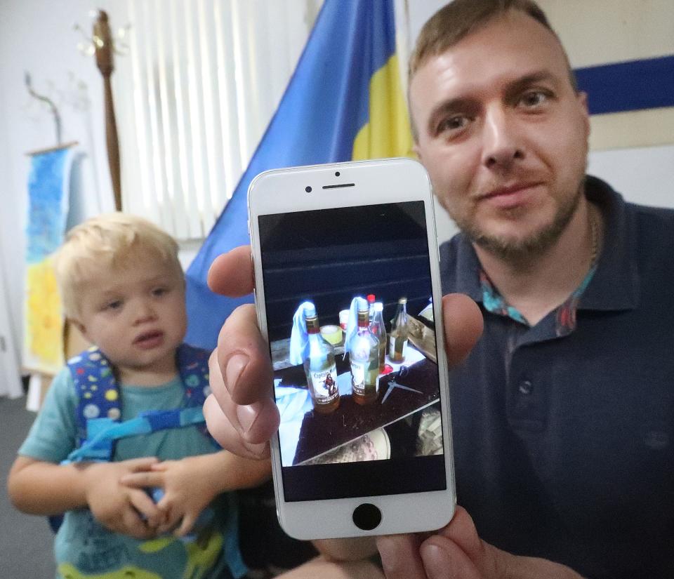 Ukrainian refugee Ostap Losyk shows a cellphone picture of a "Ukrainian Smoothie," local slang for the molotov cocktails that were made to defend against Russian troops in Ukraine. Losyk was reunited with his wife and son this week in Volusia County after spending seven months as a volunteer in the war effort.