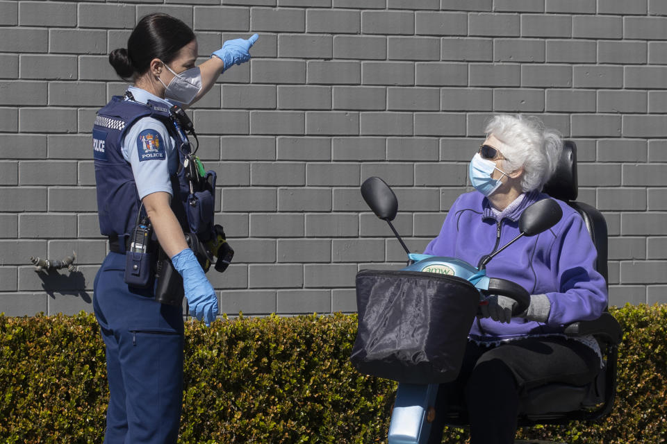 A police officer gestures to a customer to leave outside a supermarket in Auckland, New Zealand, Saturday, Sept. 4, 2021.vNew Zealand authorities say they shot and killed a violent extremist, Friday Sept. 3, after he entered the supermarket and stabbed and injured six shoppers. Prime Minister Jacinda Ardern described Friday's incident as a terror attack. (AP Photo/Brett Phibbs)