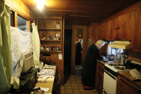 Mary Herring, 78, washes dishes in her trailer in which she has lived for 20 years, in Village Trailer Park in Santa Monica, July 12, 2012.