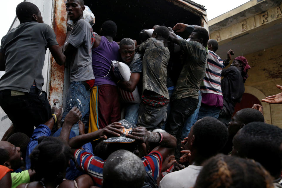 People scramble into a truck with food supplies on&nbsp;Oct. 14, 2016.