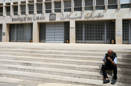 A man sits on the stairs in front of the central bank in Beirut, Lebanon May 7, 2019. REUTERS/Mohamed Azakir