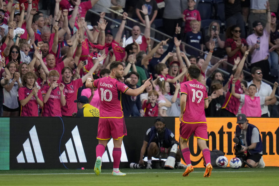 St. Louis City's Eduard Lowen (10) is congratulated by teammate Indiana Vassilev (19) after scoring during the first half of an MLS soccer match against the Vancouver Whitecaps Saturday, May 27, 2023, in St. Louis. (AP Photo/Jeff Roberson)