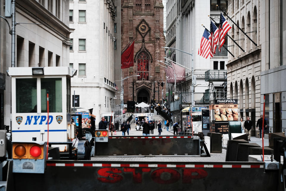 NEW YORK, NEW YORK - MAY 03: People walk along Wall Street outside of the New York Stock Exchange (NYSE) on May 03, 2023 in New York City. The Dow was slightly lower in morning trading as investors wait to see later today if the Federal Reserve will continue to raise interest rates. (Photo by Spencer Platt/Getty Images)