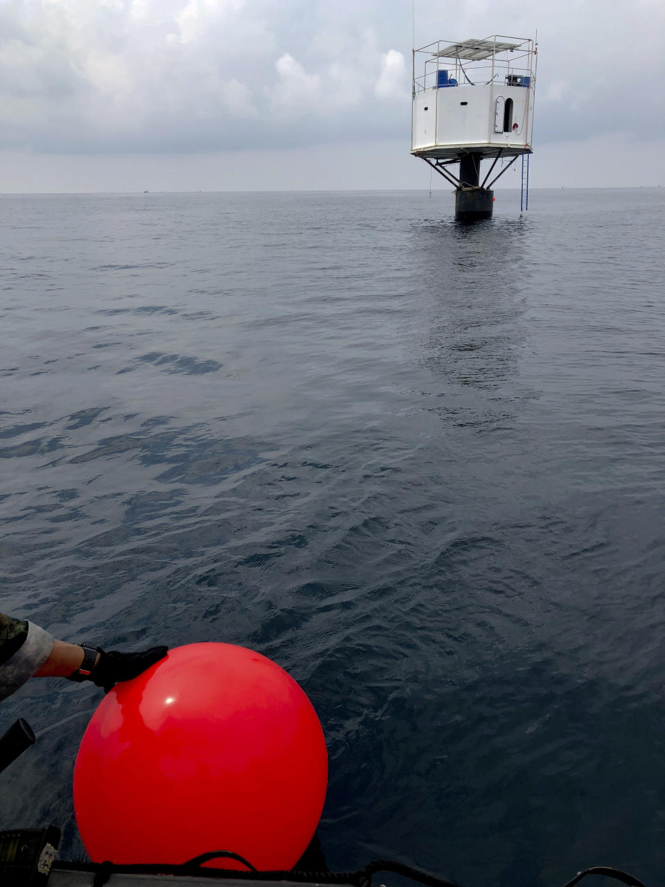 This Saturday, April 13, 2019, photo provided by Royal Thai Navy, shows a floating home lived in by an American man and his Thai partner in the Andaman Sea, off Phuket island, Thailand. Thai authorities raided Thursday, April 18, 2019, the floating home lived in by the couple who sought to be pioneers in the seasteading movement, which promotes living in international waters to be free of any nation's laws. Thailand’s navy claims they endangered national sovereignty, an offense punishable by life imprisonment or death. (Royal Thai Navy via AP)