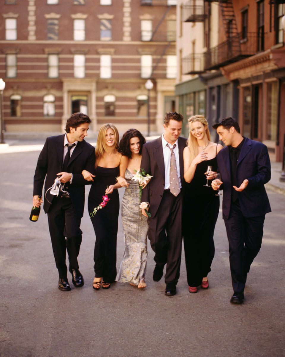 the cast walking down the street in a promotional shot