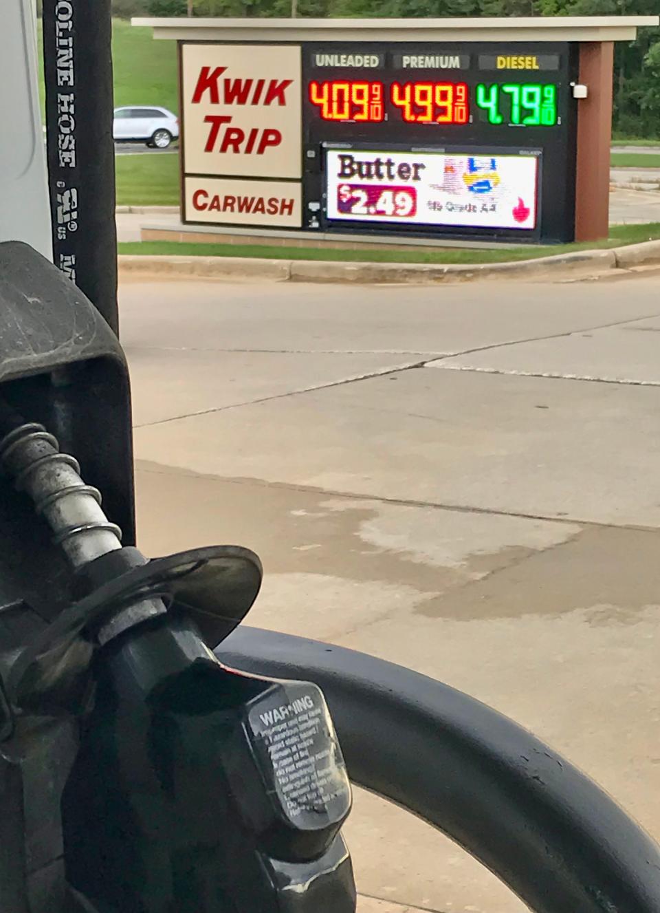 A fuel pump handle with the range of prices in the background as seen at the Taylor Heights Kwik Trip, Monday, September 26, 2022, in Sheboygan, Wis.