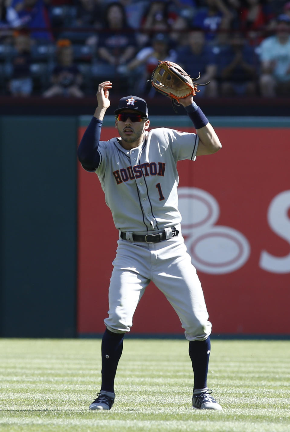 Houston Astros shortstop Carlos Correa (1) loses the ball in the sun on a pop fly by Texas Rangers' Joey Gallo during the sixth inning of a baseball game Sunday, April 21, 2019, in Arlington, Texas. (AP Photo/Mike Stone)