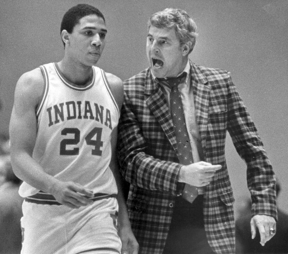 FILE - Indiana coach Bob Knight chastises player Daryl Thomas (24) for his play during the team's NCAA college basketball game against Wisconsin in Bloomington, Ind., Feb. 9, 1984. Knight, the brilliant and combustible coach who won three NCAA titles at Indiana and for years was the scowling face of college basketball, has died. He was 83. Knight's family made the announcement on social media on Wednesday night, Nov. 1, 2023, saying he was surrounded by family members at his home in Bloomington, Ind. (AP Photo/Dean Rutz, File)