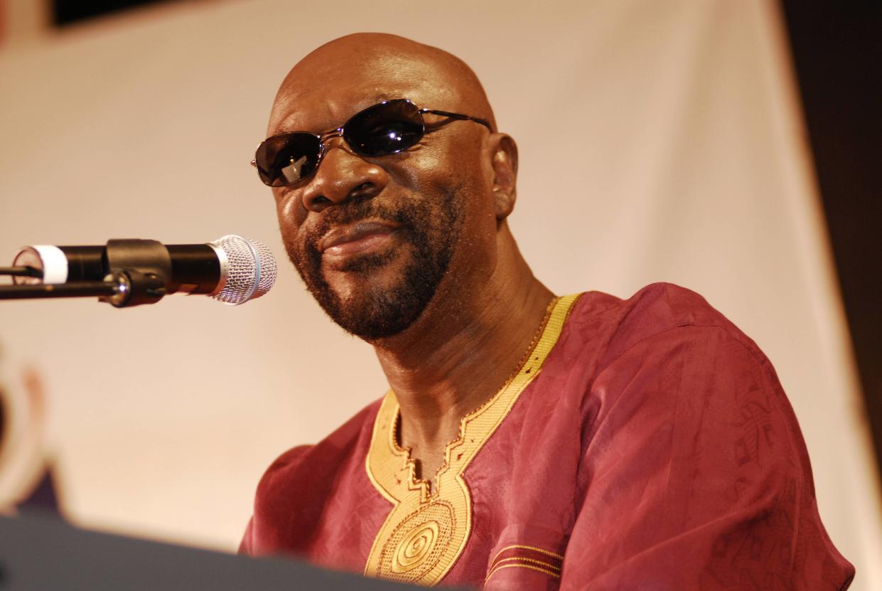 Isaac Hayes,wearing sunglasses, at the keyboard.