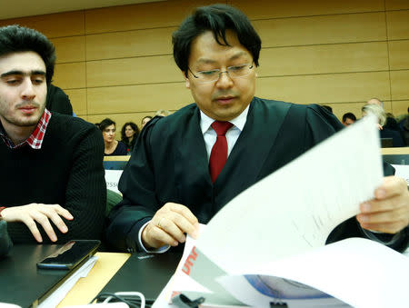 FILE PHOTO: Syrian refugee Anas Modamani accompanied by his lawyer Chan-Jo Jun attends a court session against Facebook over a selfie with Merkel at the district court in Wuerzburg, Germany February 6, 2017. REUTERS/Ralph Orlowski