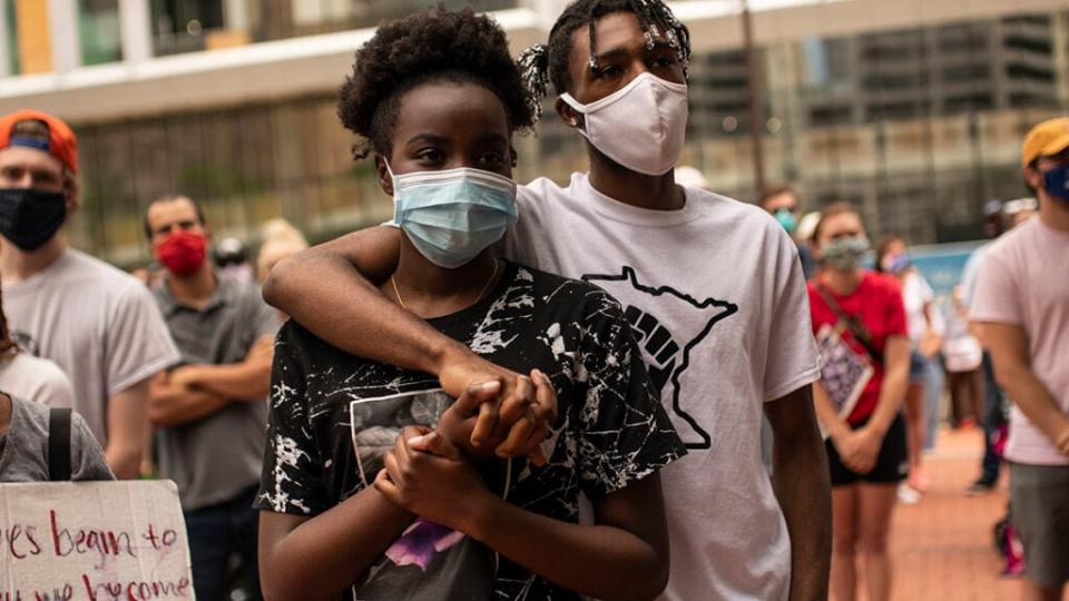 A group of people listen to speakers recount stories of their loved ones who were killed by police during a demonstration outside the Hennepin County Government Center on June 13, 2020 in Minneapolis, Minnesota. (Photo by Stephen Maturen/Getty Images)