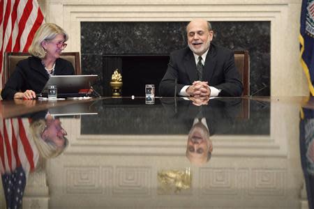 U.S. Federal Reserve Chairman Ben Bernanke (R) smiles as he holds a town hall event for teachers at the Federal Reserve Board's building in Washington, November 13, 2013. REUTERS/Jonathan Ernst