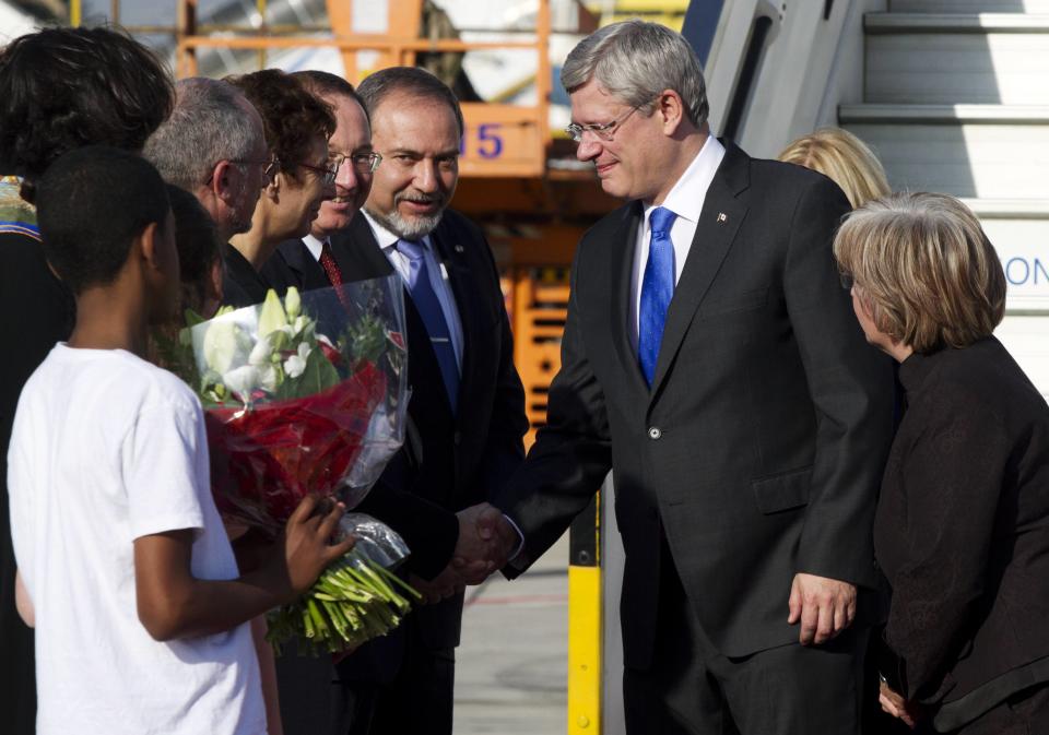 Canada's Prime Minister Harper and his wife are greeted at Ben Gurion Airport near Tel Aviv