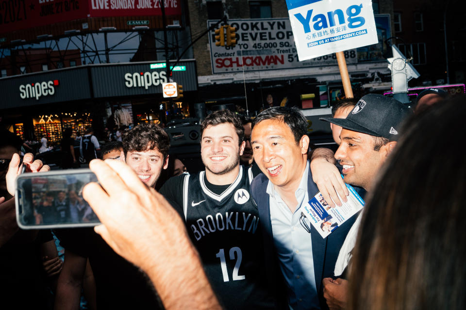 A crowd of Brooklyn Nets fans pose for pictures with Yang outside of Barclay’s Center in Brooklyn.