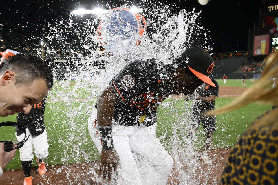 Baltimore Orioles' Jorge Mateo, center, is doused after a baseball game against the Oakland Athletics, Friday, Sept. 2, 2022, in Baltimore. (AP Photo/Nick Wass)