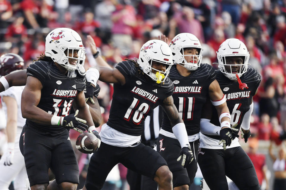 Louisville linebacker Jaylin Alderman (24) celebrates with teammates after recovering a fumbleduring the second half of an NCAA college football game against Virginia Tech in Louisville, Ky., Saturday, Nov. 4, 2023. Louisville won 34-3. (AP Photo/Timothy D. Easley)