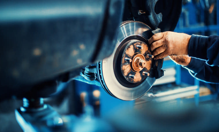 A mechanic working on a car