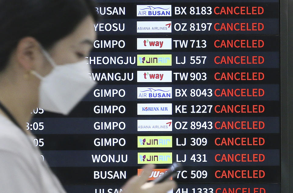 An electronic signboard shows canceled flights as Typhoon Hinnamnor travels toward the Korean Peninsula at Jeju International Airport on Jeju Island, South Korea, Monday, Sept. 5, 2022. (Byun Ji-chul/Yonhap via AP)