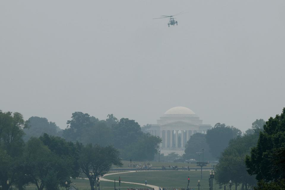 Marine One, with President Joe Biden on board, flys past the Jefferson Memorial as it appears hazy from wild fire smoke (Getty Images)