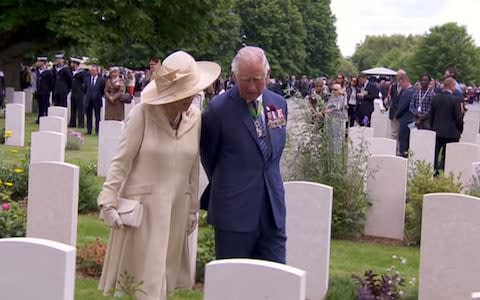 Prince Charles and Camilla walk amongst the graves - Credit: BBC