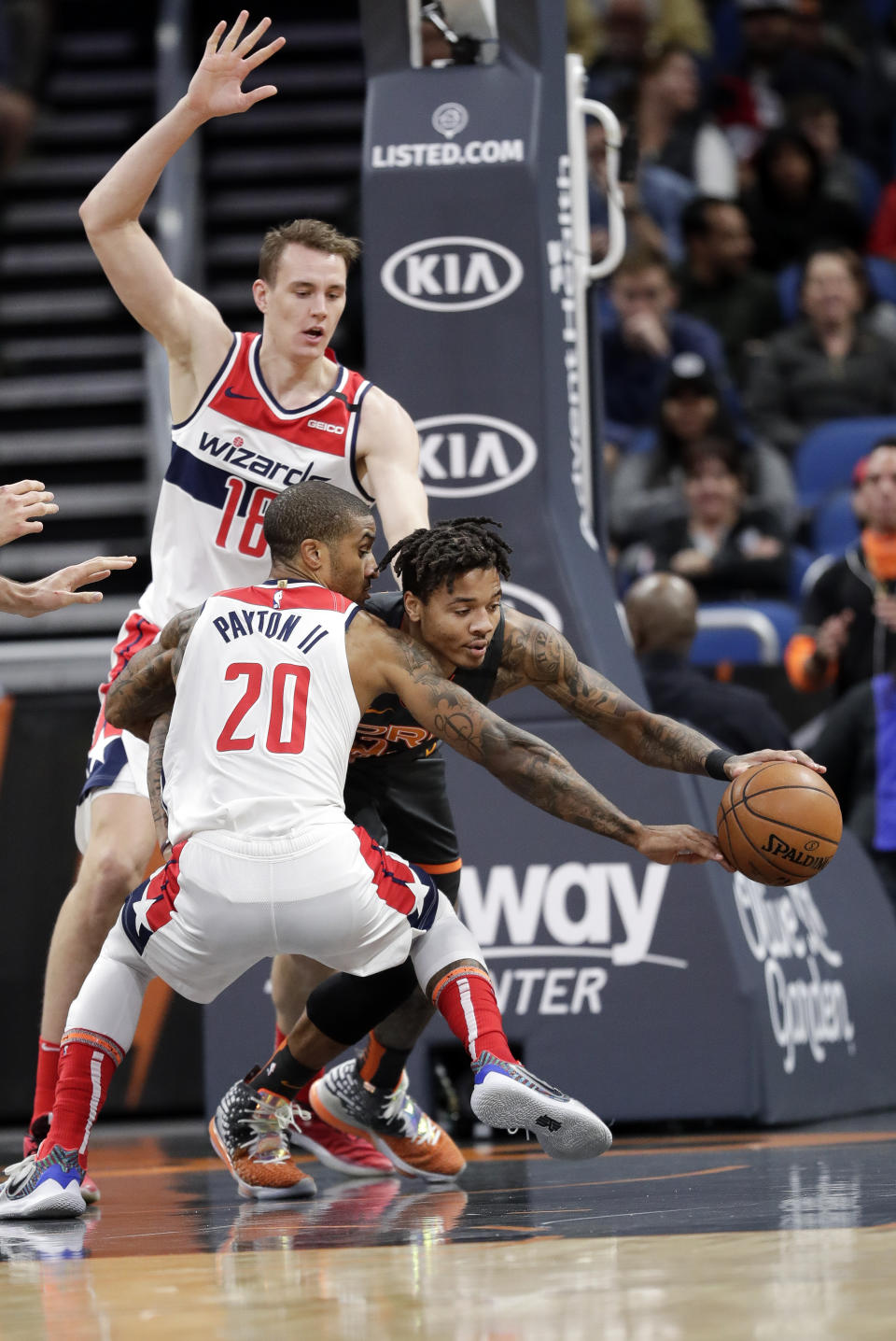 Orlando Magic guard Markelle Fultz, center, goes after a loose ball between Washington Wizards center Anzejs Pasecniks, left, and guard Gary Payton II (20) during the first half of an NBA basketball game Wednesday, Jan. 8, 2020, in Orlando, Fla. (AP Photo/John Raoux)